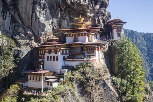 Stunning view of Tiger's Nest Monastery perched on a cliff in Bhutan's mountains.